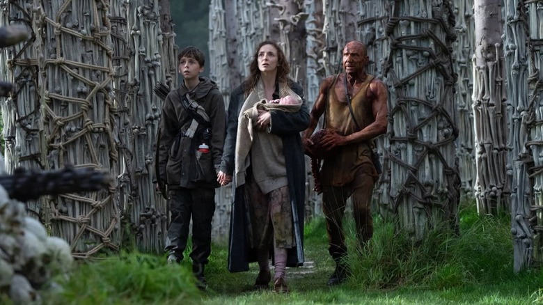 Spike, Isla, and Dr. Kelson walking through the bone temple in 28 Years Later