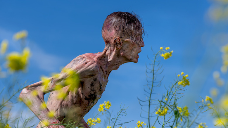 The skinny zombie standing up in a field in 28 Years Later