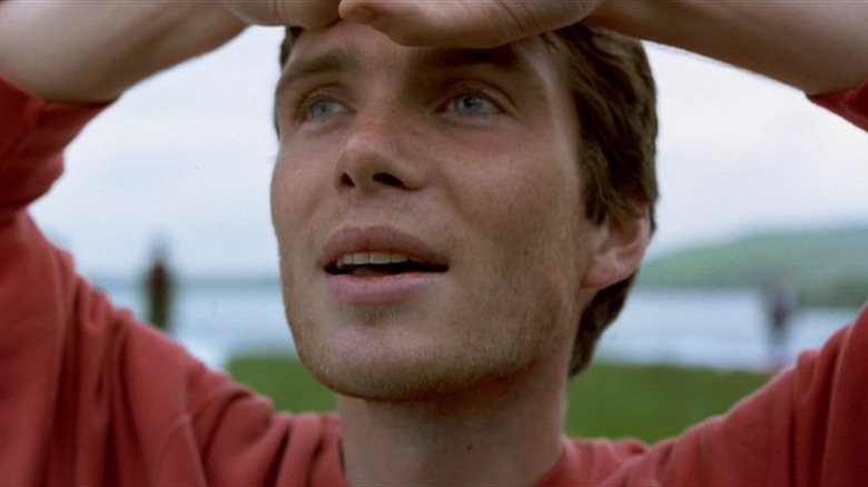 Cillian Murphy as Jim with his hands over his head in 28 Days Later