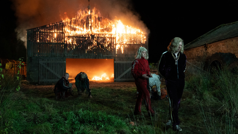 Jimmy Crystal and the Jimmys huddled outside of a burning barn in 28 Years Later: The Bone Temple