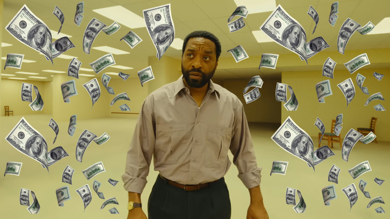 Chiwetel Ejiofor as Clark walking through the Backrooms surrounded by money in Backrooms