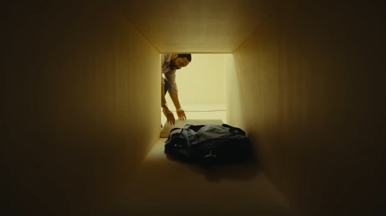 Chiwetel Ejiofor as Clark opening up a crawlspace in Backrooms