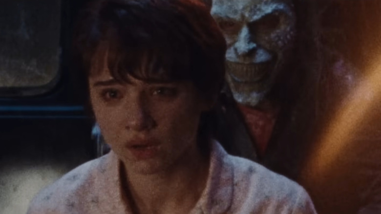 The Grabber looming behind Gwen in Black Phone 2