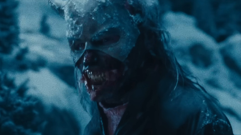 Ethan Hawke as The Grabber with the bottom of his mask removed in the snow in Black Phone 2