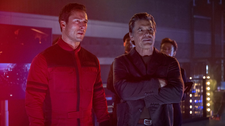 Glen Powell as Ben Richards standing back stage next to Josh Brolin as Killian in The Running Man (2025)