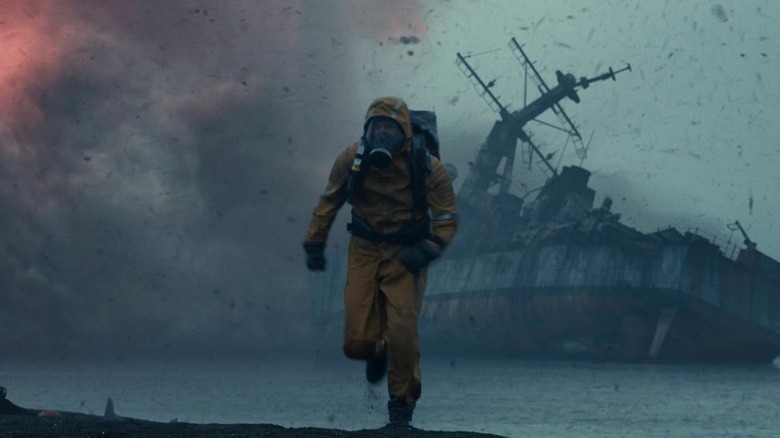 A man in a hazmat suit running from a storm in Greenland 2: Migration