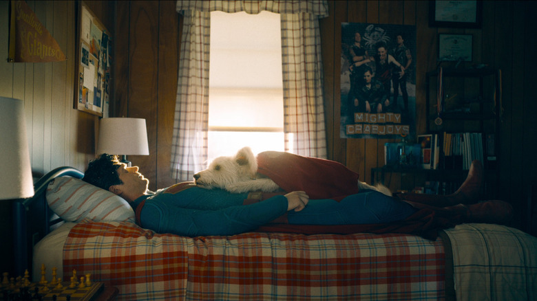 David Corenswet as Superman laying on his bed with Krypto in Superman