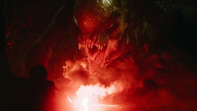 The D-rex lit up by a flare in Jurassic World Rebirth