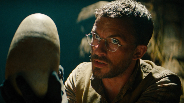Jonathan Bailey as Dr. Henry Loomis holding a dinosaur egg in his hand in Jurassic World Rebirth