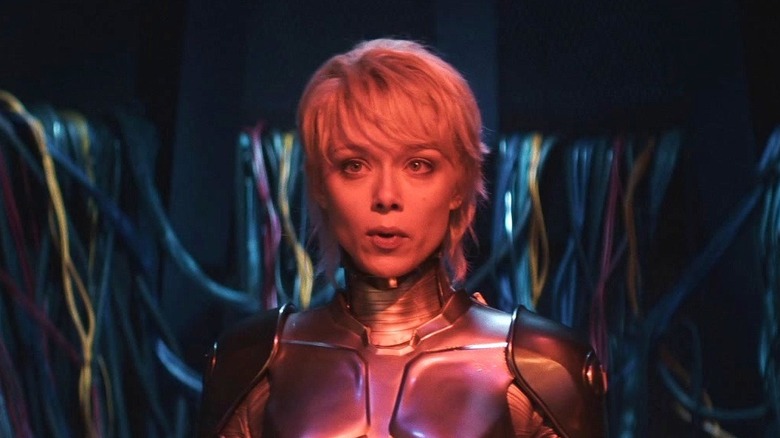 Ivanna Sakhno as Amelia with her robot body standing in front of a bunch of wires in M3GAN 2.0