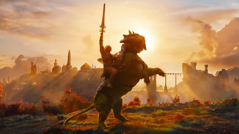 Nicholas Galitzine as He-Man holding his sword in the air while riding Battle Cat in Masters of the Universe (2026)