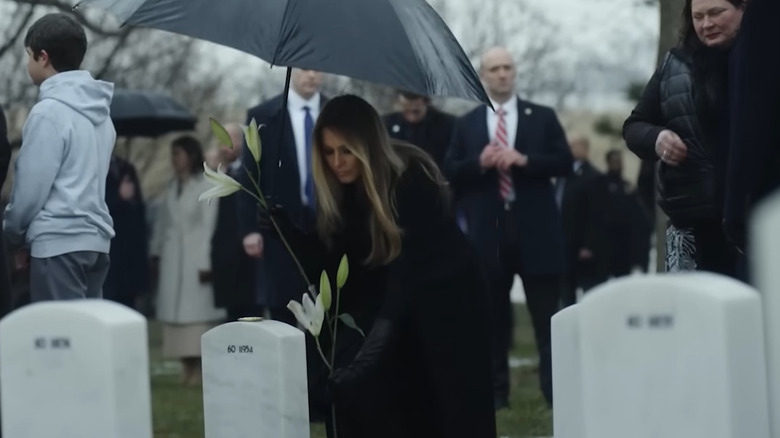 Melania Trump laying flowers on a grave in Melania