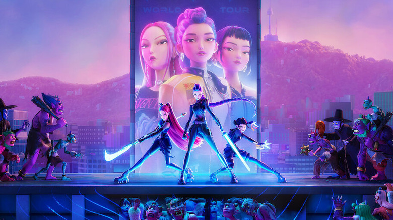 Mira, Rumi, and Zoey on stage flanked by demons in KPop Demon Hunters
