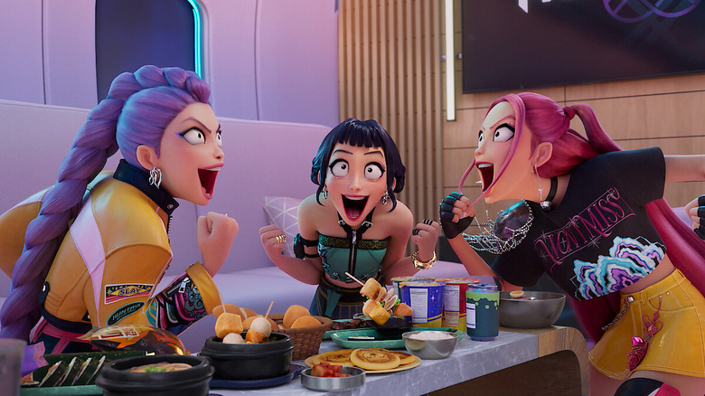 Mira, Rumi, and Zoey laughing while eating food in KPop Demon Hunters