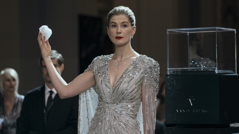 Rosamund Pike as Veronika Vanderberg holding up a big diamond in Now You See Me: Now You Don't