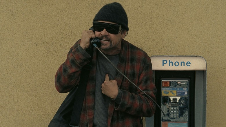 Leonardo DiCaprio as Bob yelling into a pay phone in One Battle After Another
