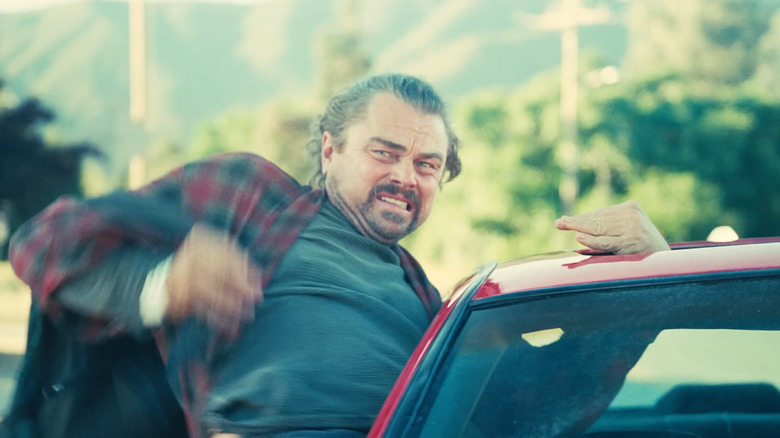 Leonardo DiCaprio as Bob leaning out of a car window in One Battle After Another