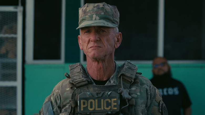 Sean Penn as Col. Steven J. Lockjaw standing in his military police gear in One Battle After Another