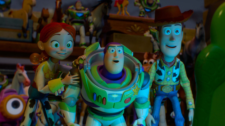 Jessie, Buzz, and Woody looking at Lillypad's screen in Toy Story 5