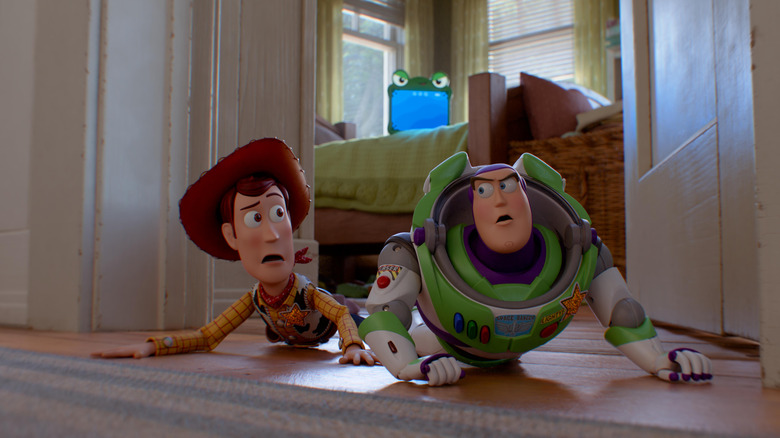 Woody and Buzz crawling on the floor in Toy Story 5