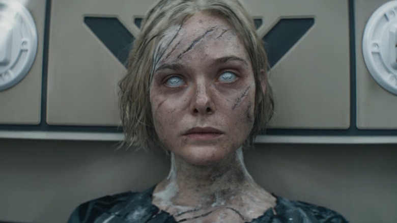 Tessa, beaten up and in need of repair, laying on a table in Predator: Badlands