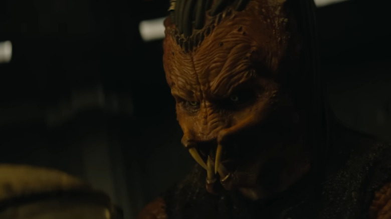 Dek holding his brother's helmet in Predator: Badlands