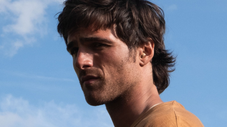 Jacob Elordi as Hig staring into the distance against the backdrop of a blue sky in The Dog Stars