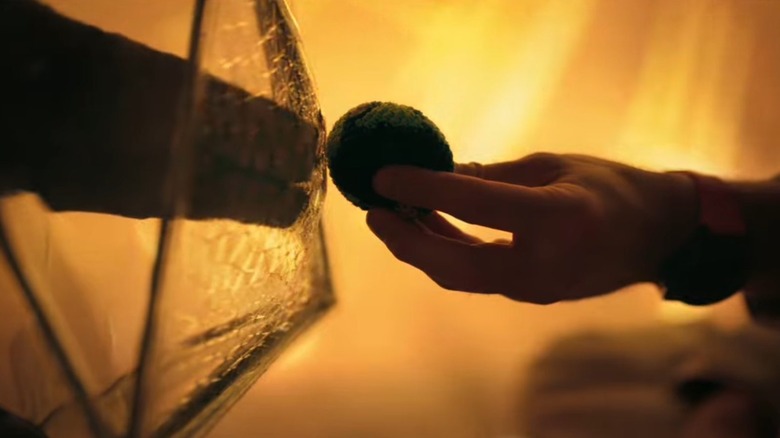 Ryland holding up the Earth hacky sack to Rocky in Project Hail Mary