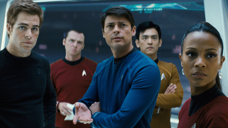 Kirk, Scotty, Bones, Sulu, and Uhura standing together on the bridge of the Enterprise in Star Trek (2009)