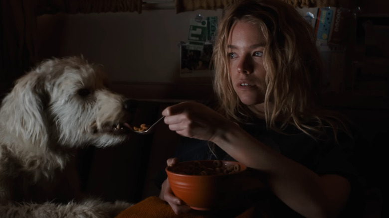 Milly Alcock as Kara Zor-El feeding Krypto cereal in Supergirl