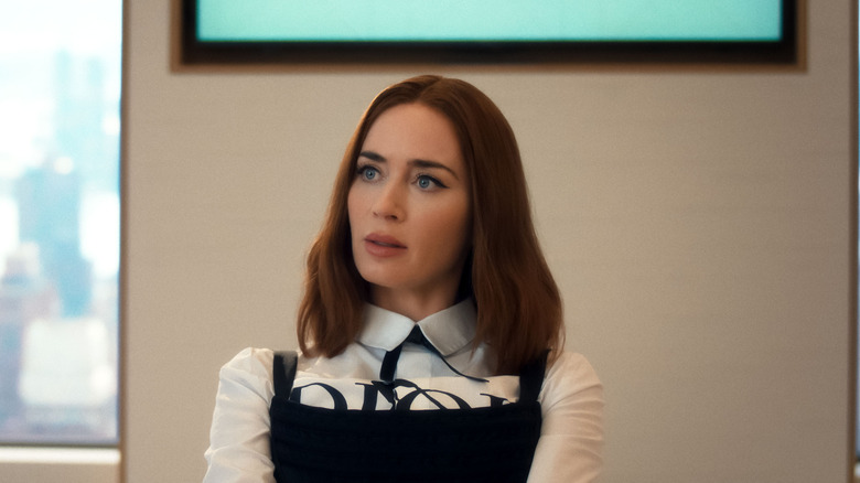 Emily Blunt as Emily Charlton sitting at a table in The Devil Wears Prada 2