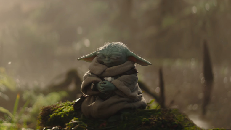 Grogu meditating on a log in The Mandalorian and Grogu