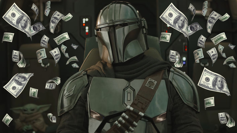 Mando in the cockpit of his new Razor Crest surrounded by money with Grogu in the background in The Mandalorian and Grogu