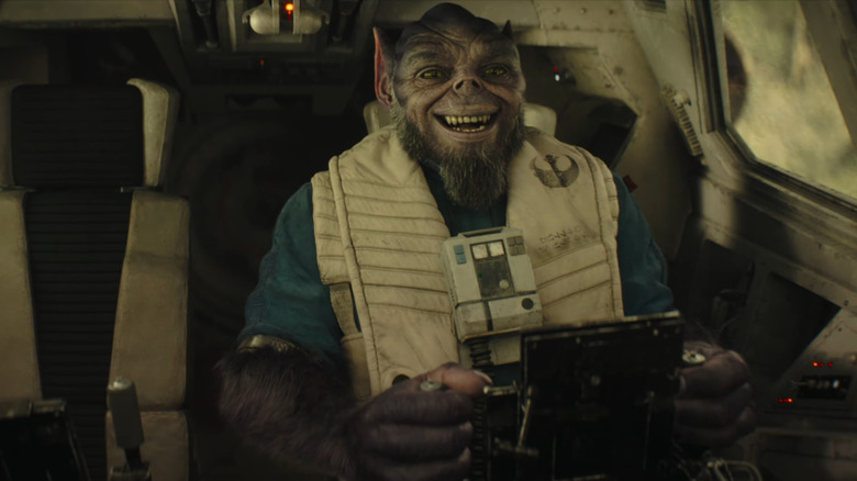 Zeb laughing in the cockpit of his ship in The Mandalorian and Grogu