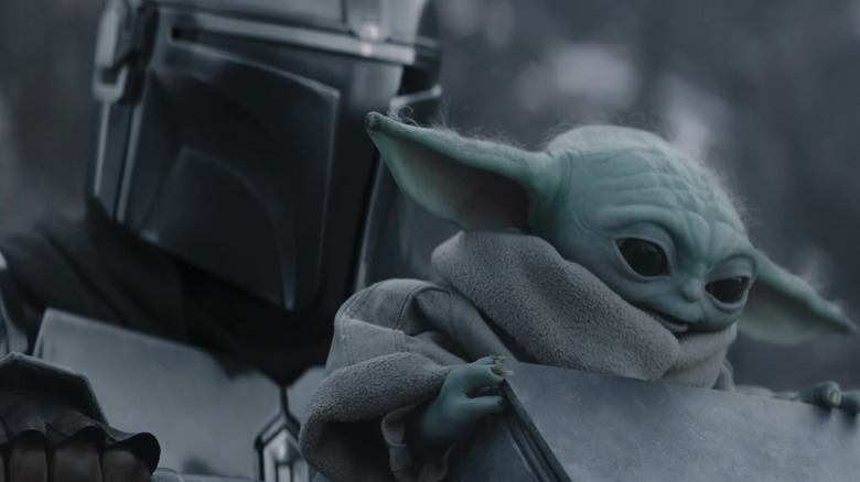 Mando and Grogu riding on a walker in The Mandalorian and Grogu
