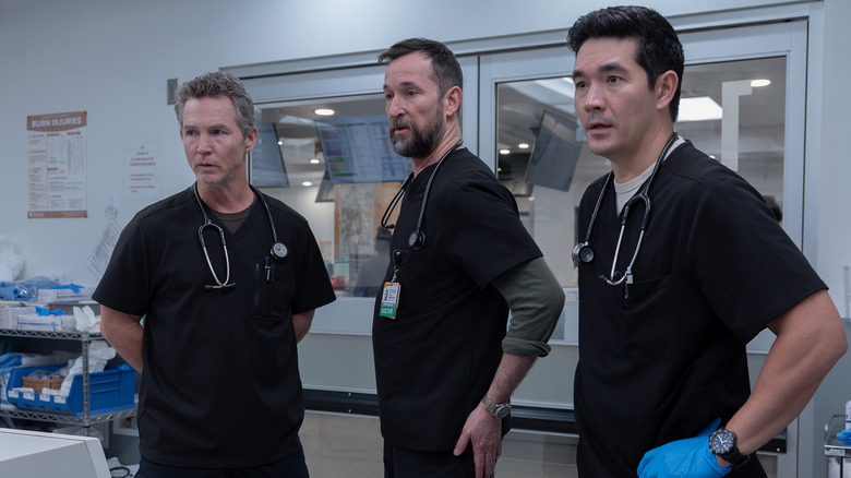 Abbot, Robby, and Shen looking at something on The Pitt