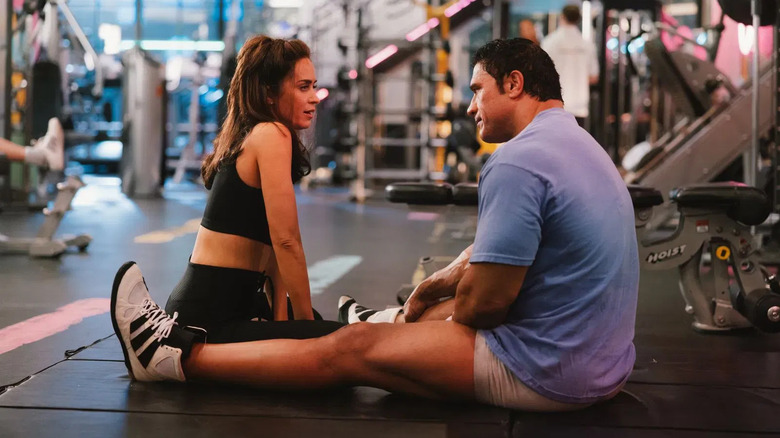 Emily Blunt as Dawn with Dwayne Johnson as Mark in the gym in The Smashing Machine