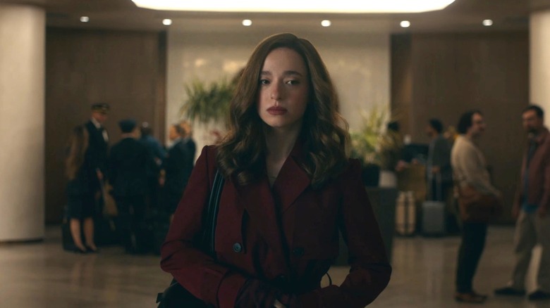 Mikey Madison as Frances Haugen walking down a hallway in a red jacket in The Social Reckoning