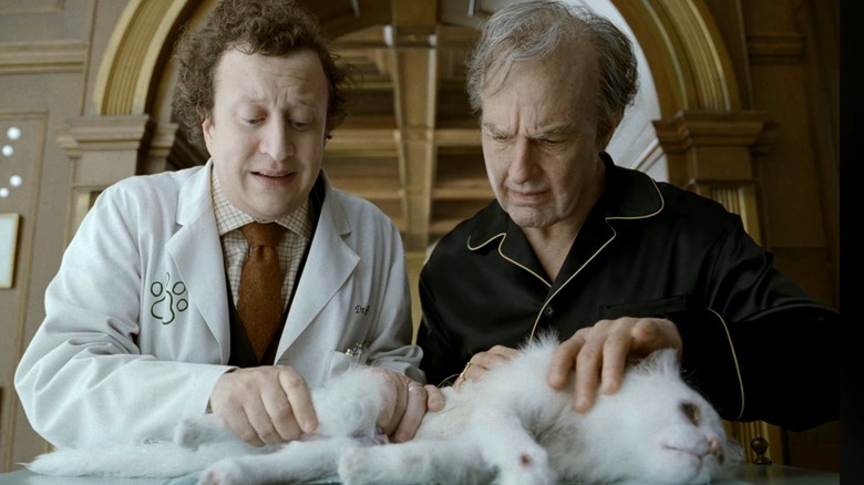 Ross Hat as Dr. Berg and Tom Cruise as Digger Rockwell looking at his cat in Digger