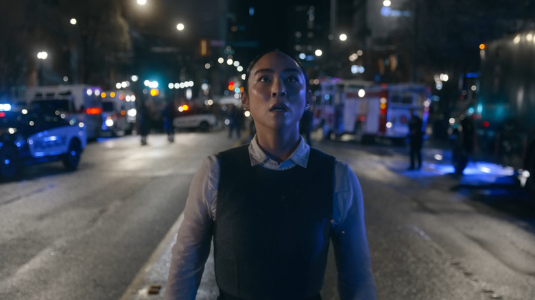 Greta Lee as Eve Kim looking up at the sky in horror in Tron: Ares