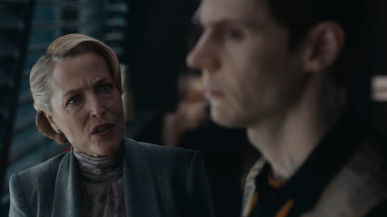 Gillian Anderson as Elisabeth Dillinger staring sternly at Evan Peters as Julian Dillinger in Tron: Ares