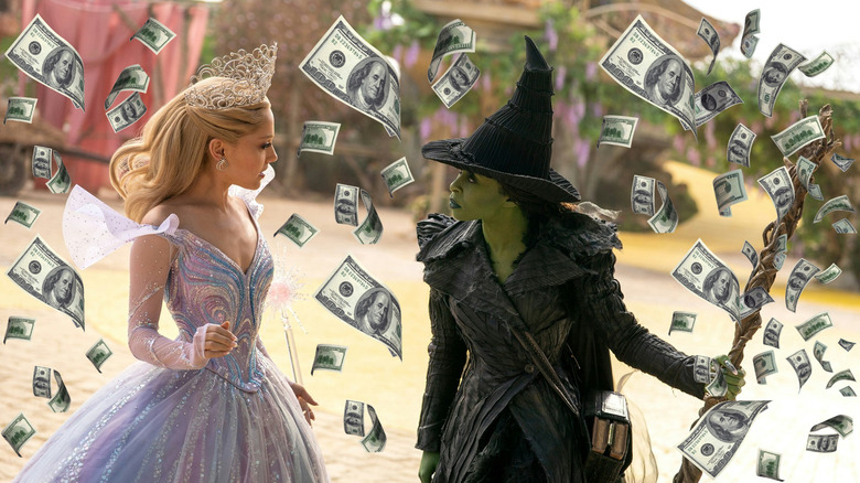 Glinda and Elphaba surrounded by money in Wicked: For Good