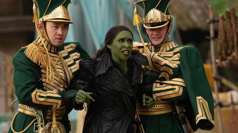 Cynthia Erivo as Elphaba being carried away by two guards in Wicked: For Good
