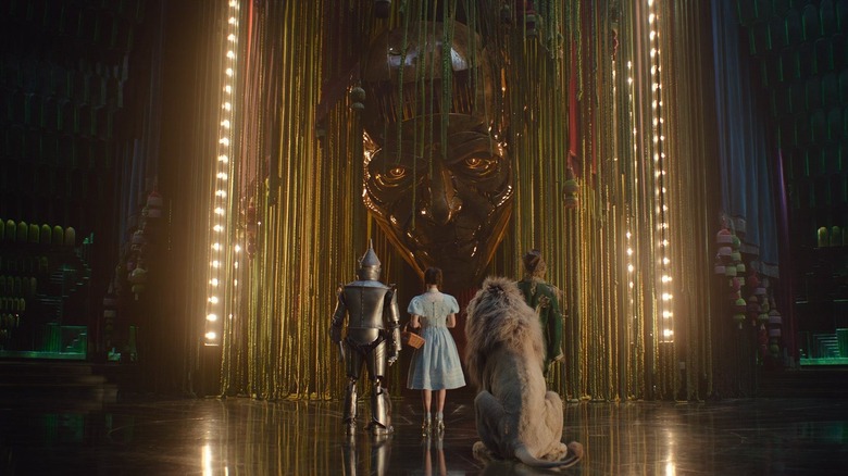 The Tin Man, Dorothy, the Cowardly Lion, and the Scarecrow facing Oz in Wicked: For Good