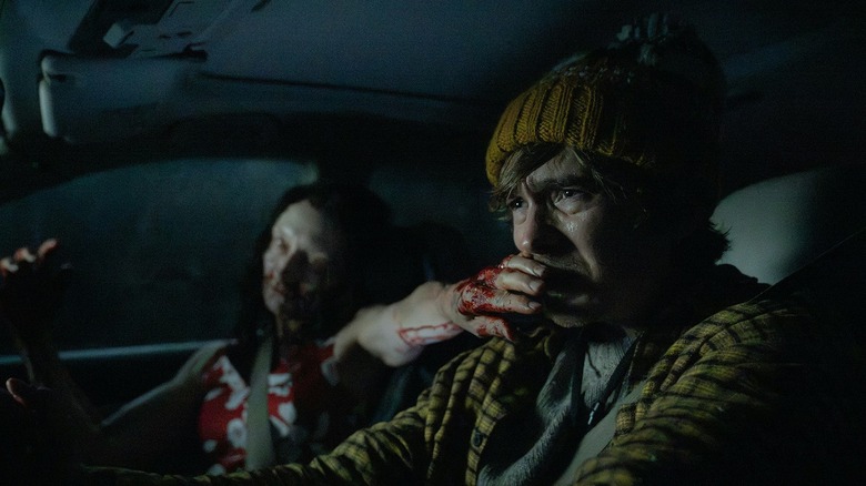 Austin Abrams as Bryan with a zombie covering his mouth in Resident Evil (2026)