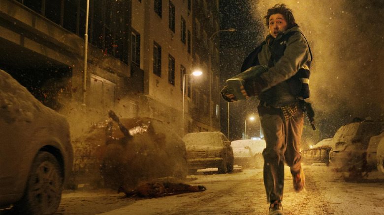Austin Abrams as Bryan running down the street with the package in Resident Evil (2026)