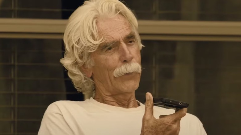 T.L. Norris holding a cell phone on 