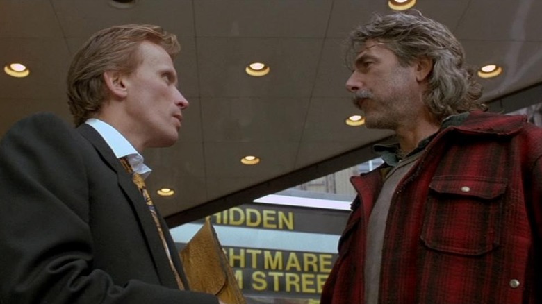 Roland (Peter Weller) and Richie (Sam Elliott) looking at each other in "Shakedown."