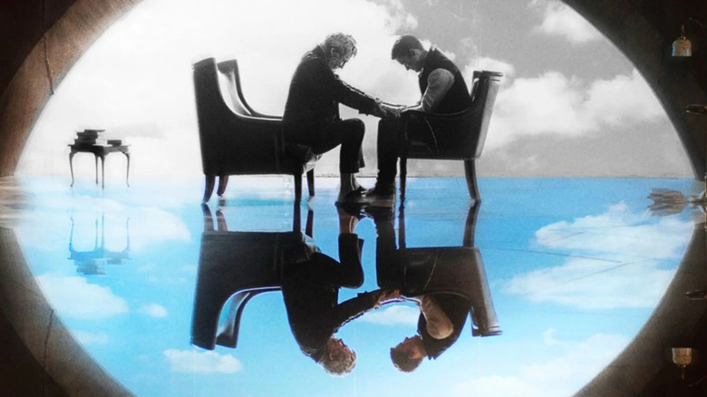The Giver taking Jonas' hands on the cover of The Giver