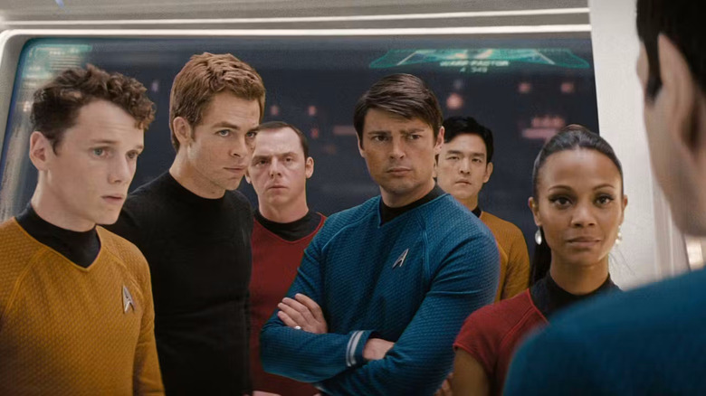 Chekov, Kirk, Scotty, McCoy, Sulu, and Uhura listening to Spock in Star Trek (2009)